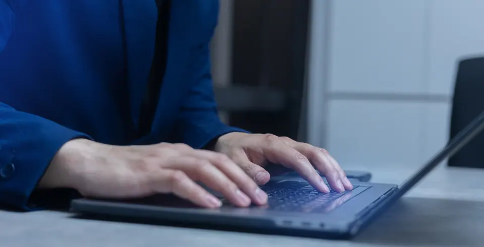 Close up on businessman hand type on keyboard laptop to check about programming of security system software in the dark operation room for internet and…