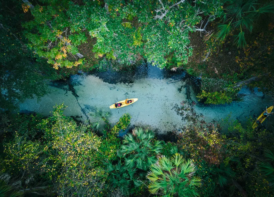 Couple kayaking florida springs - high angle drone - freshwater river