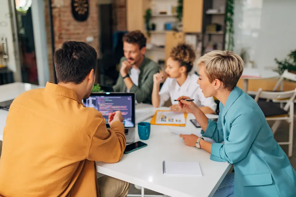 A small group of developers work together to solve coding problems