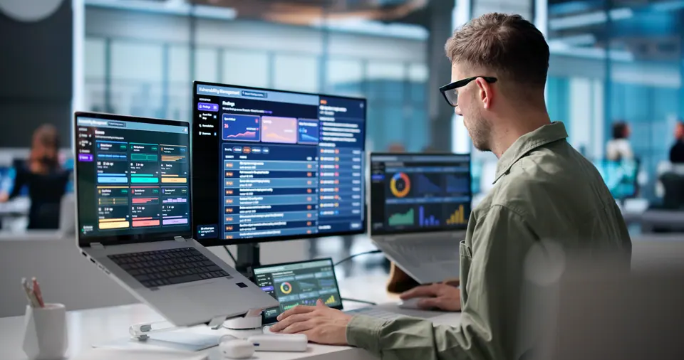 Young cybersecurity analyst uses laptop to review threat detection data carefully