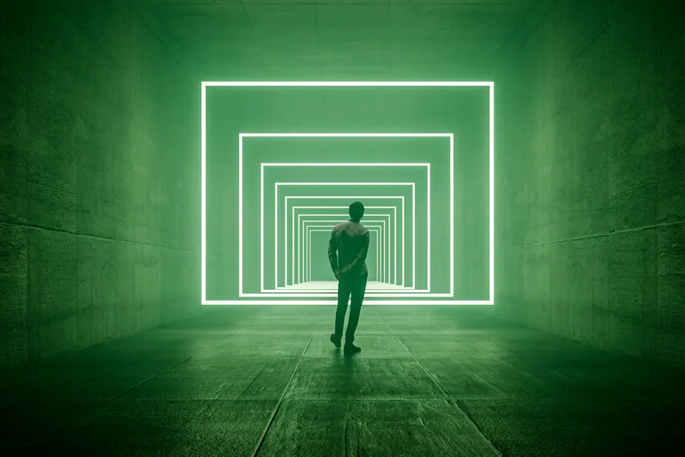Young man standing in VR corridor