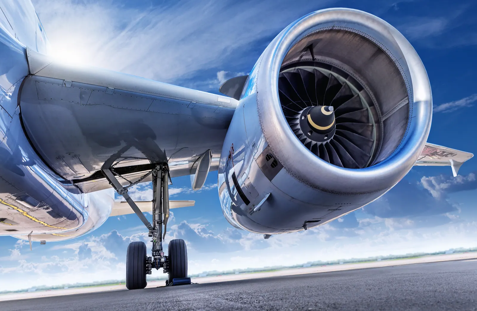 Close-up of a passenger aircraft engine and landing gear