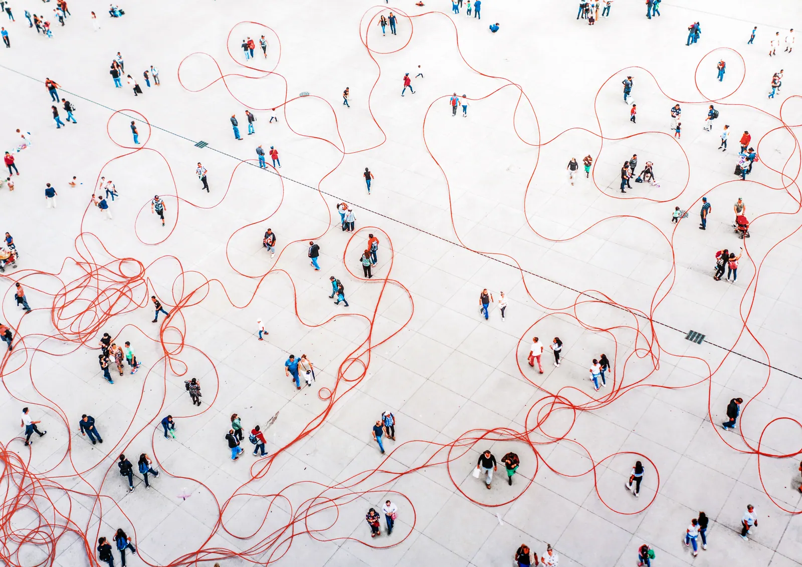 Overhead view of people connected by a network of red paths