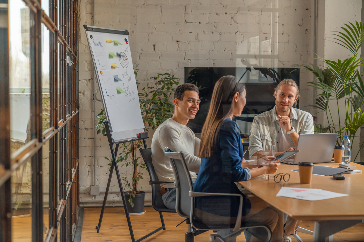 Indoor shot of creative team discussing ideas in business meeting. Multi ethnic business people working together on new project in office.